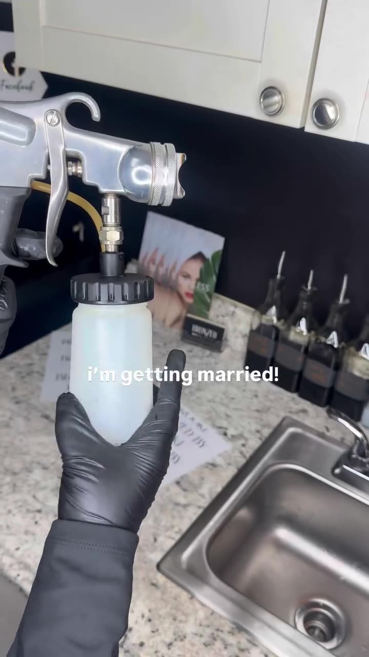 Brooke mixing tan solution at her studio counter